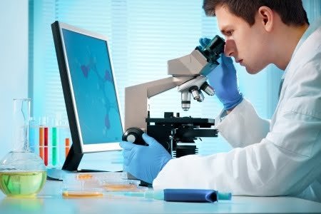 Man looking in microscope